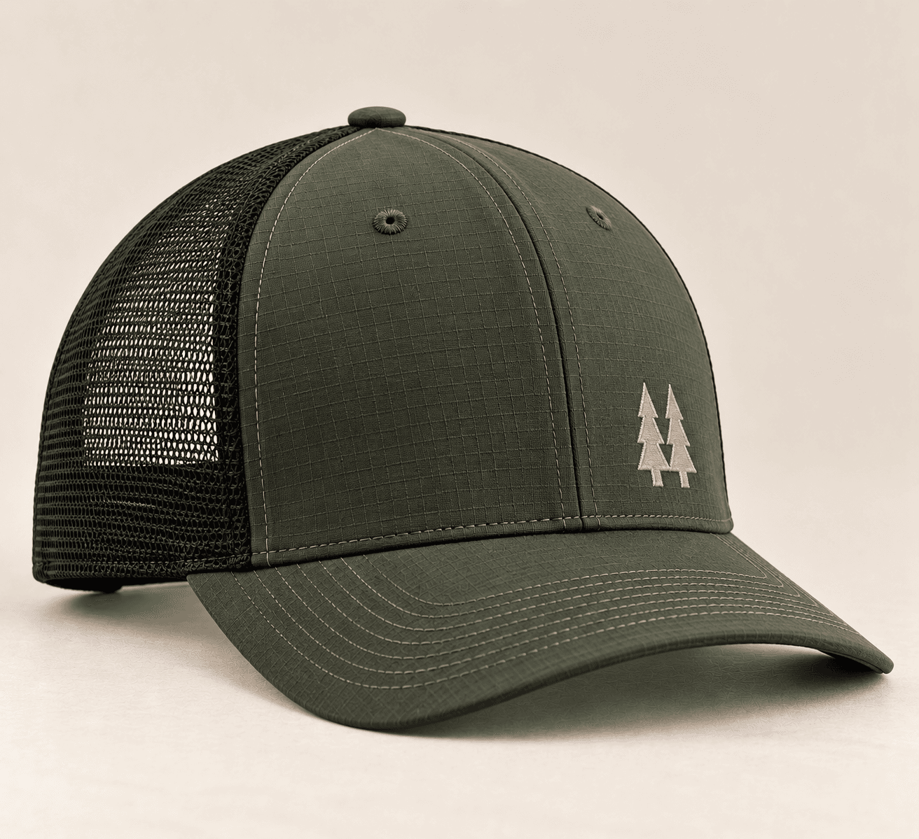 Bloom Trail Cap in forest green with a mesh back and a small tan pine-tree mark on the front