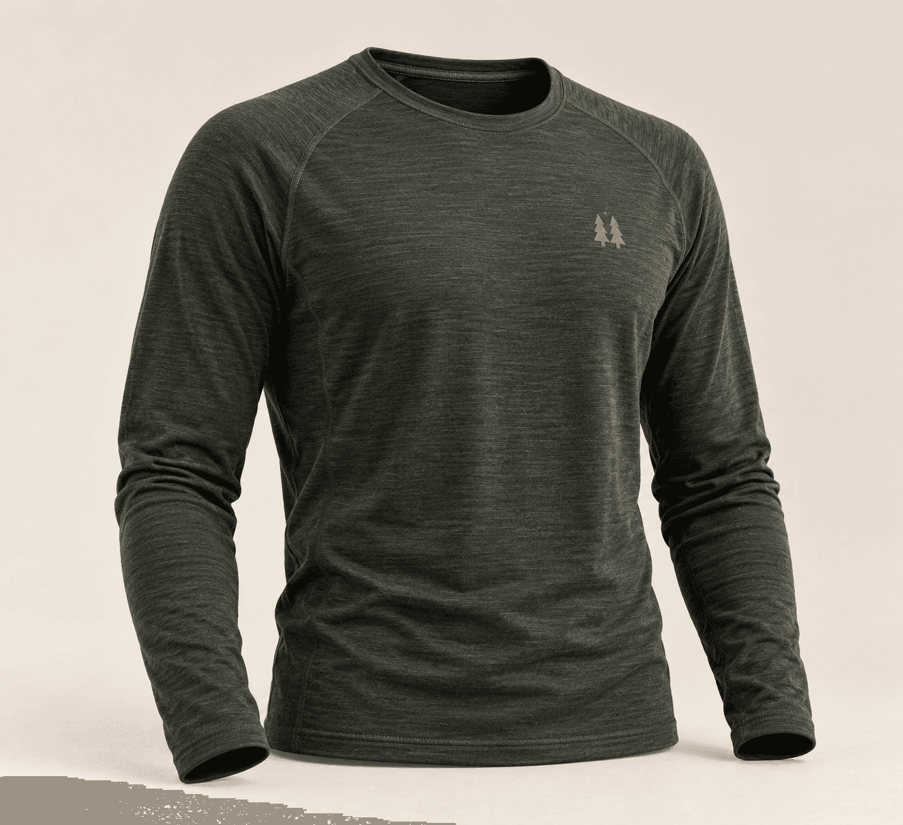 Fernbrook Merino Base Layer in charcoal, a long-sleeve raglan crew with a small pine-tree mark on the chest