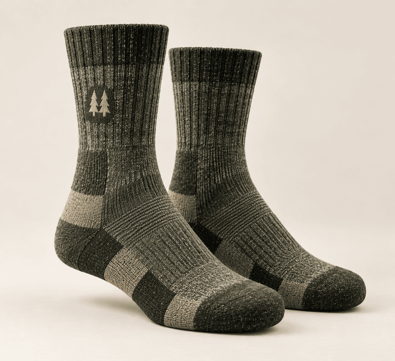 A pair of olive Hollis & Hart merino trail socks with cushioned heels and a pine-tree mark