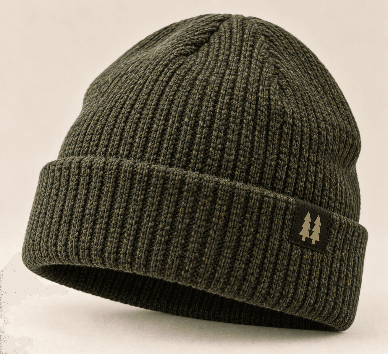 Ridgeline Merino Beanie in olive heather, a rib-knit cap with a small woven pine-tree label on the cuff