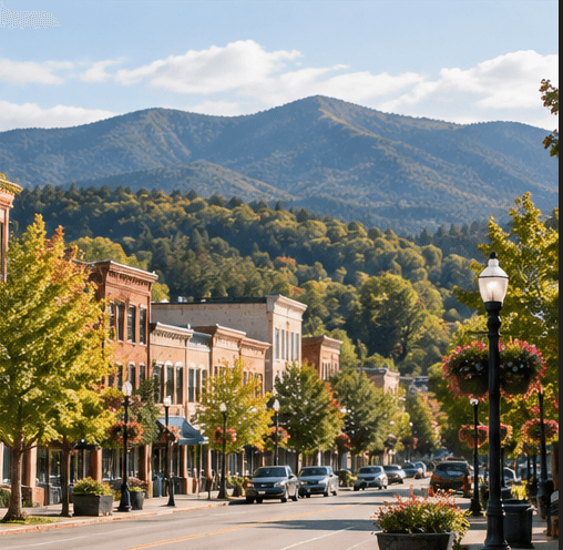 Small mountain town main street with autumn trees and a ridge beyond